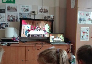 Dzieci oglądają teatr w telewizji.