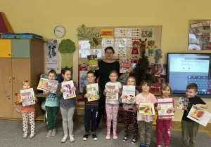 Zdjęcie grupowe dzieci w sali przedszkolnej.