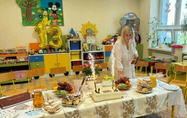 Pani Wice Dyrektor stoi przy stolena kt&oacute;rym jest tort.