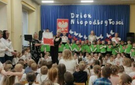 Dzieci stoją ,uśmiechają się .