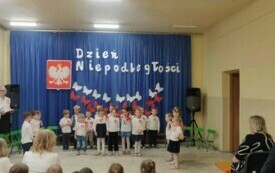 Dzieci stoją recytują wiersze patriotyczne.