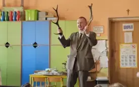 Leśnik pokazuje dzieciom poroże jelenia