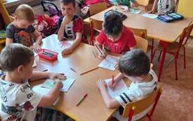 Dzieci rysują obrazki przy stolikach